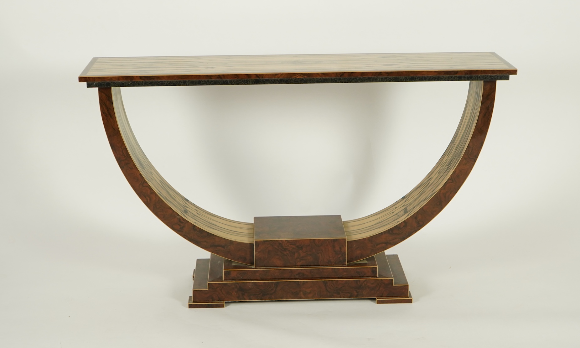 An Art Deco style white ebony and walnut console table